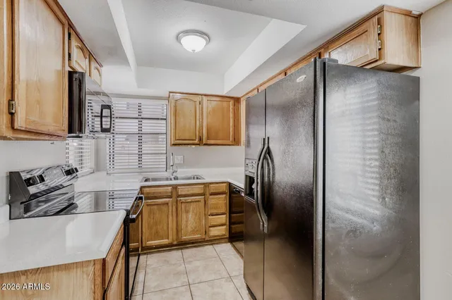 a kitchen with stainless steel appliances granite countertop a refrigerator and a sink