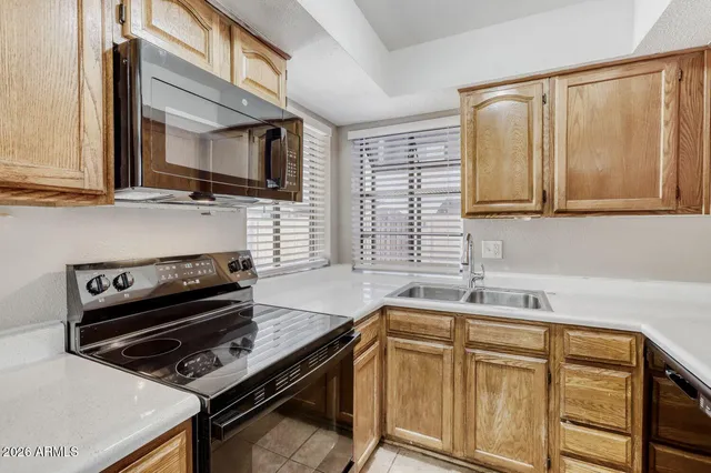 a kitchen with a stove microwave and sink