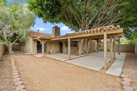 a view of a house with a tree in the background