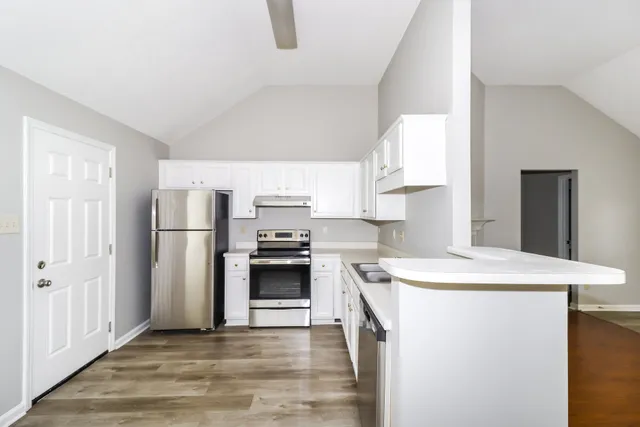 a kitchen with a sink a stove and refrigerator