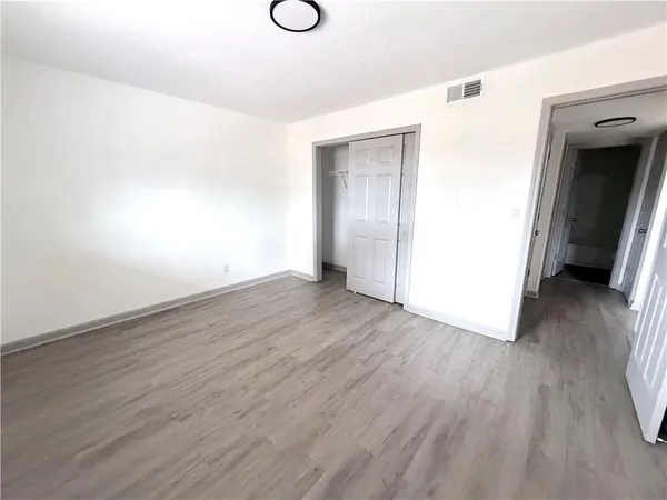 a view of a room with wooden floor