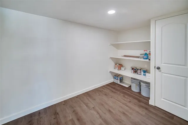 a room with a wooden floor and shoes