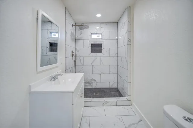 a bathroom with a sink a toilet and mirror