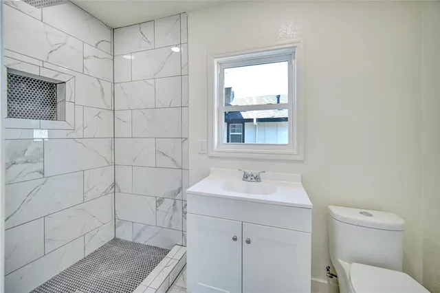 a bathroom with a sink toilet and shower