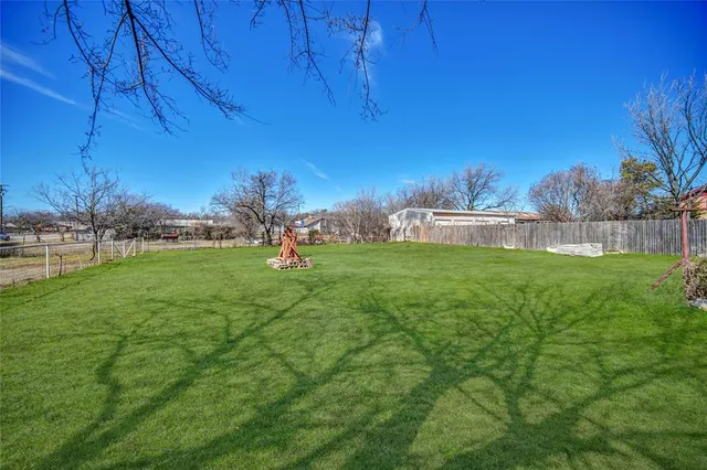 a view of yard with grass and trees