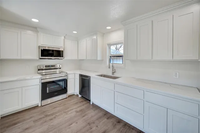 a kitchen with sink cabinets and stainless steel appliances