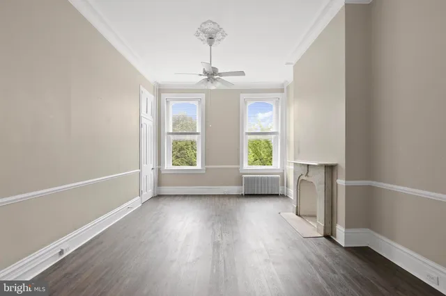 wooden floor in an empty room with a window
