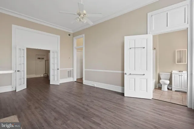 a view of empty room with wooden floor