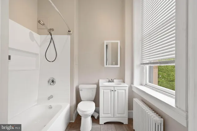 a bathroom with a toilet sink a shower and a bathtub