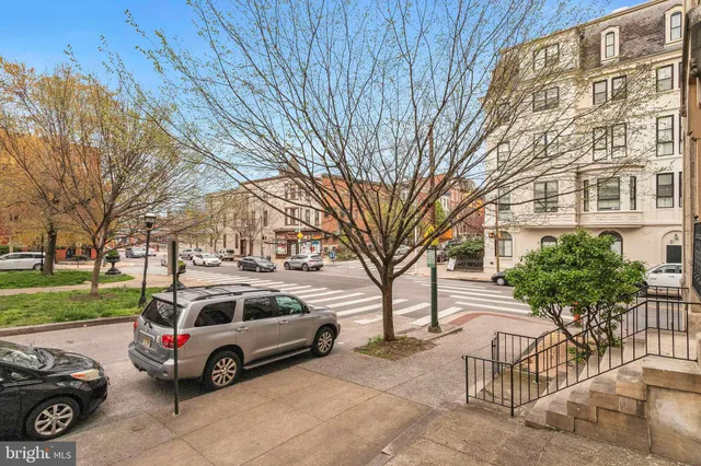 a car parked in front of a brick house