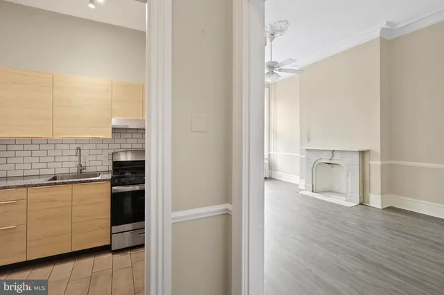 a view of a kitchen with a sink and a refrigerator