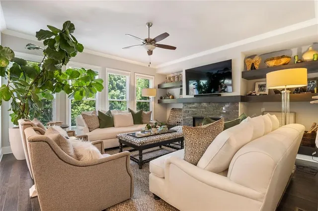 a living room with furniture a flat screen tv and a fireplace