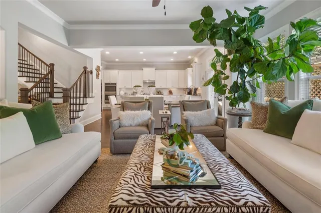 a living room with furniture plant and a chandelier