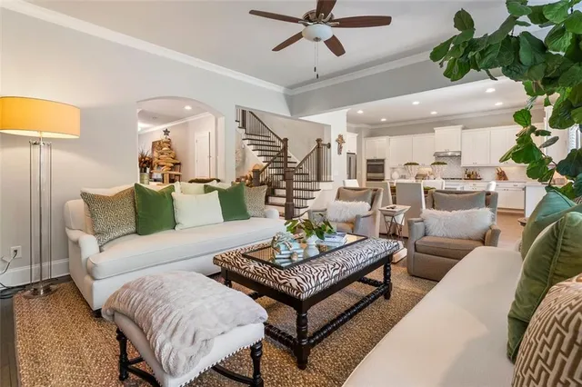 a living room with furniture and a chandelier