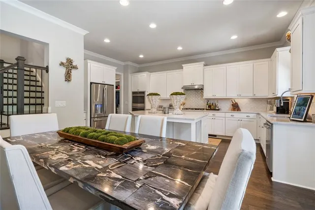 a kitchen with a refrigerator a sink dishwasher and a stove top oven