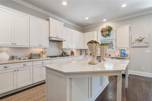 a kitchen with sink stove and cabinets