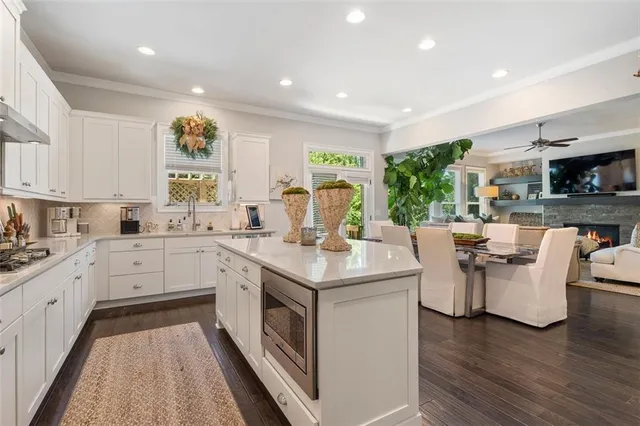 a large kitchen with stainless steel appliances granite countertop a stove and a sink