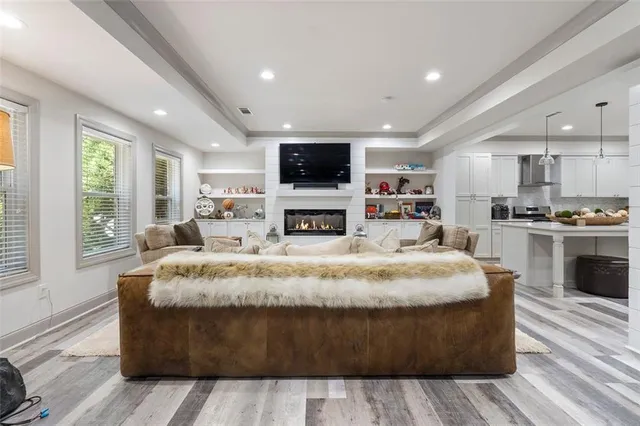 a kitchen with a sink a refrigerator and chairs