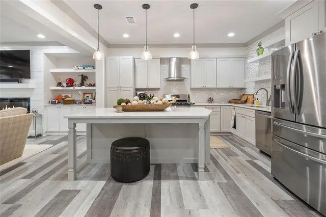 a patio with a table and chairs and a barbeque