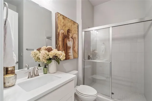 a bathroom with a sink toilet and shower