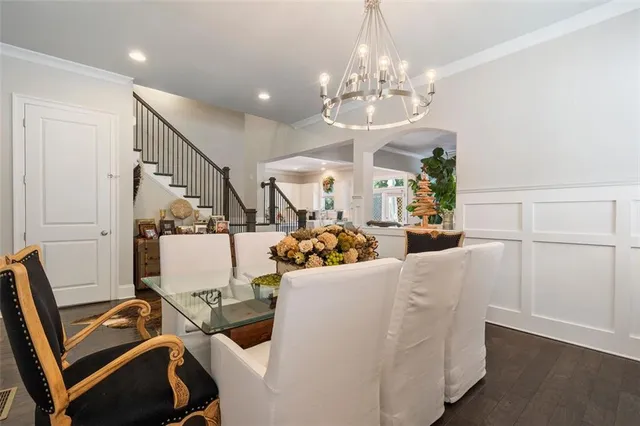 a view of a dining room with furniture and a chandelier