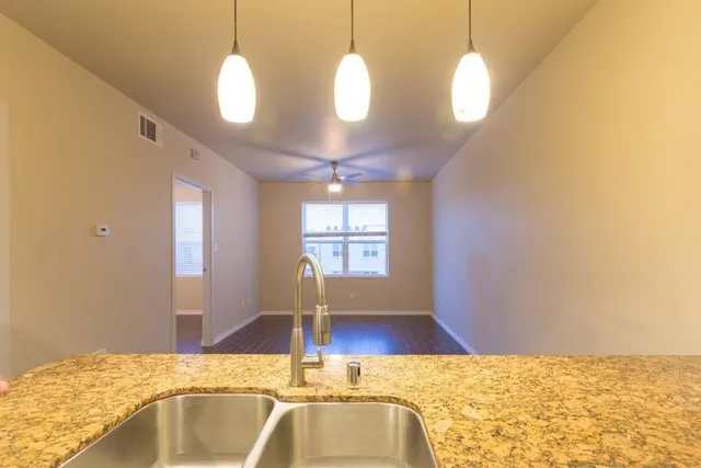 a view of a kitchen with kitchen island and natural light