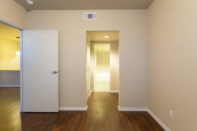 a view of room with wooden floor and closet