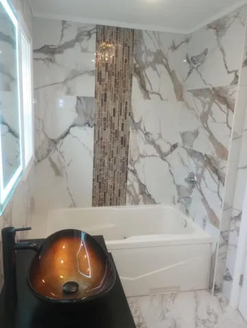 a white toilet sitting next to a bathroom sink