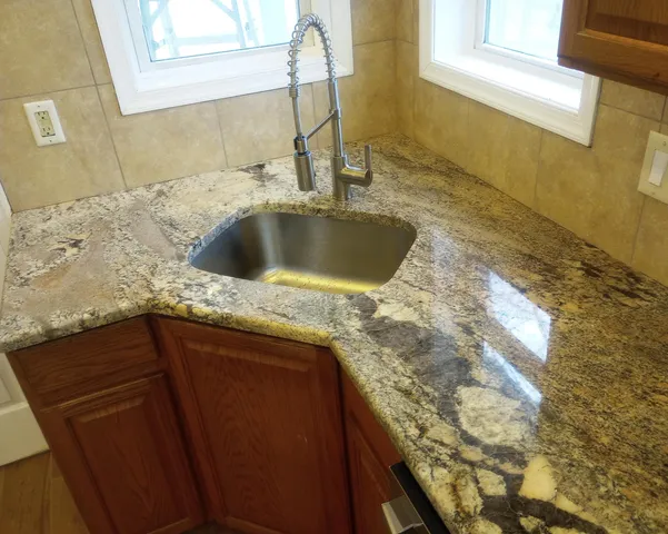 a kitchen with a sink stove and cabinets
