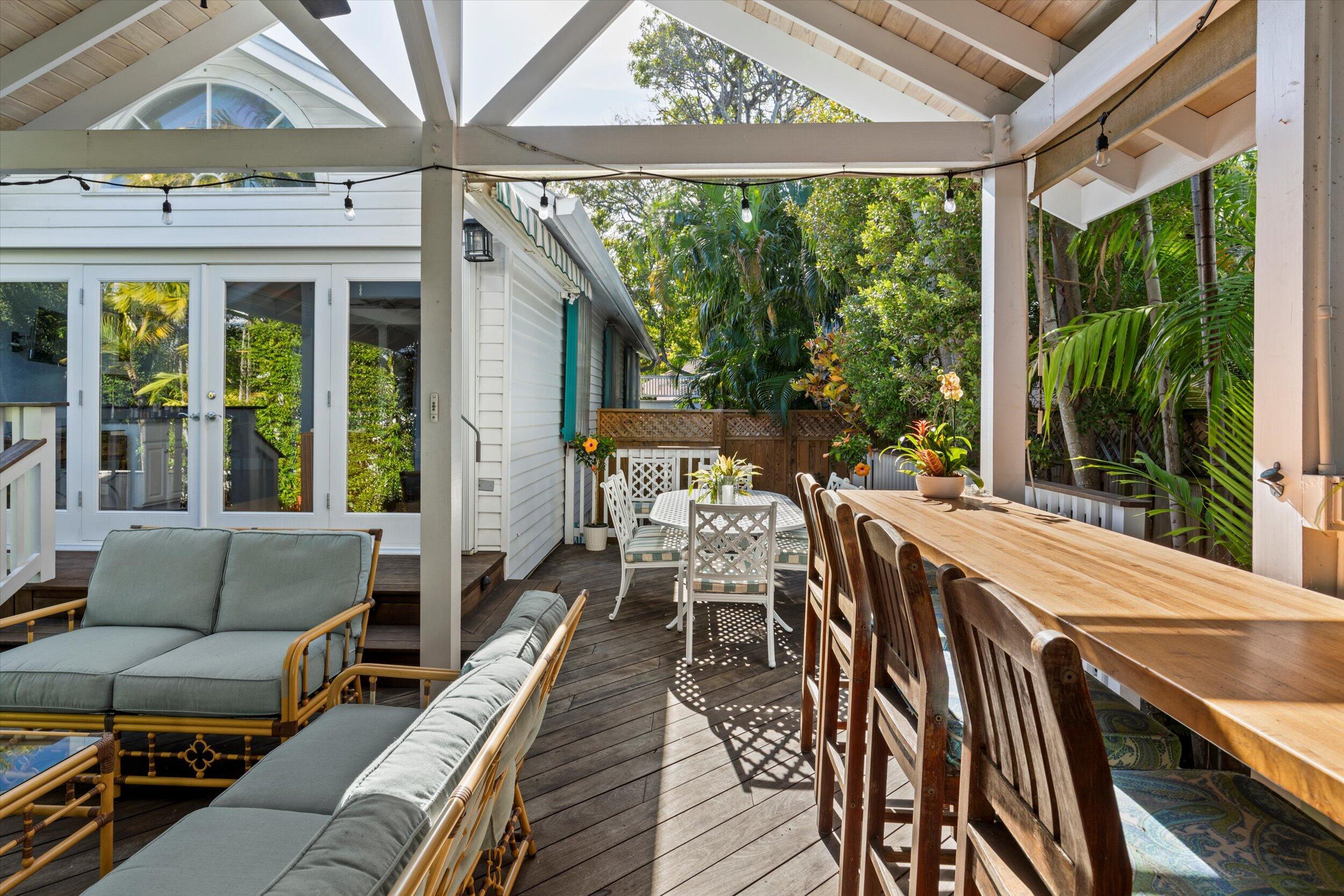 709 Eaton Street Key West, FL 33040 - Photo 16 of 37 a view of a patio with table and chairs in front of a house