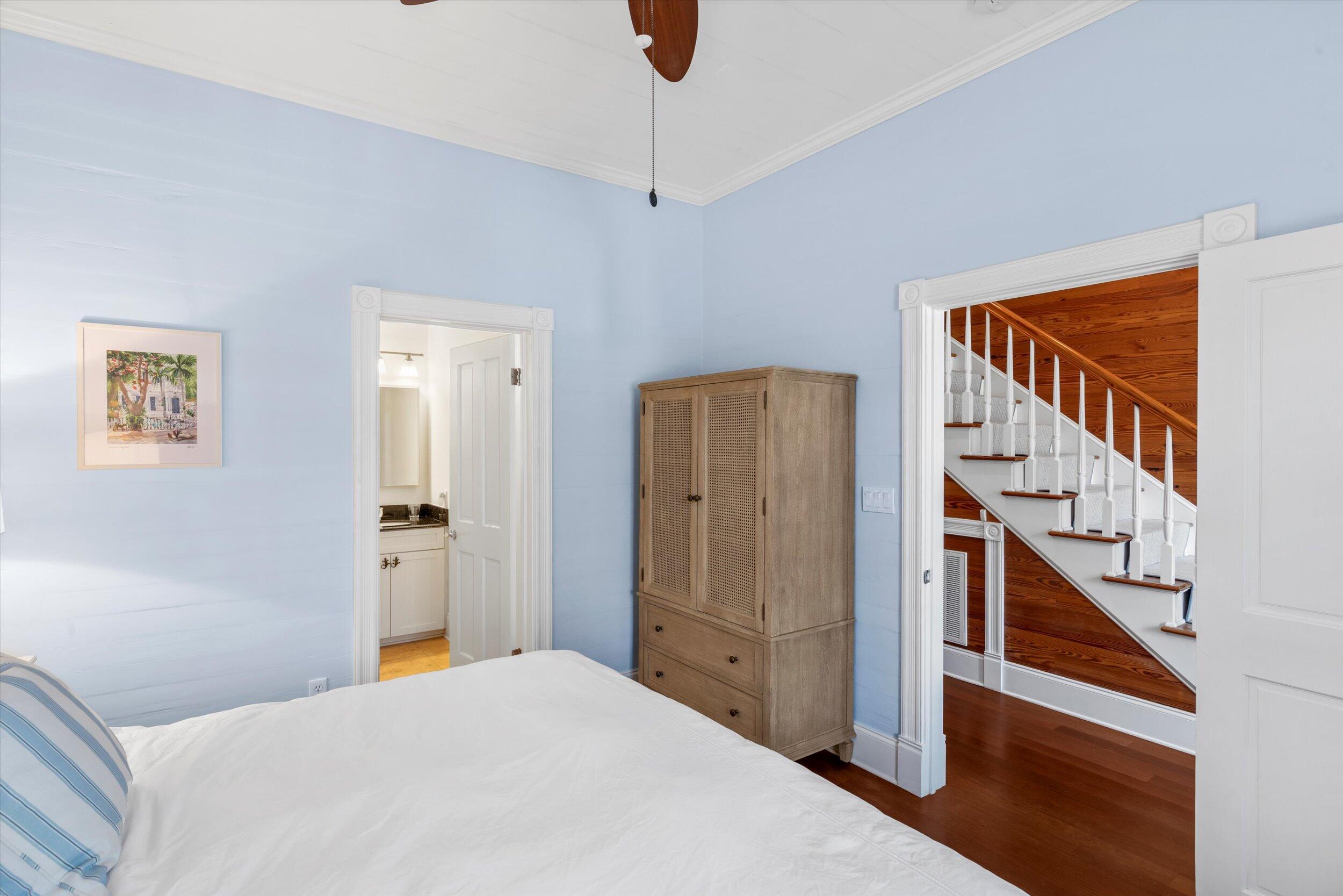 709 Eaton Street Key West, FL 33040 - Photo 19 of 37 a bedroom with a bed and a chandelier