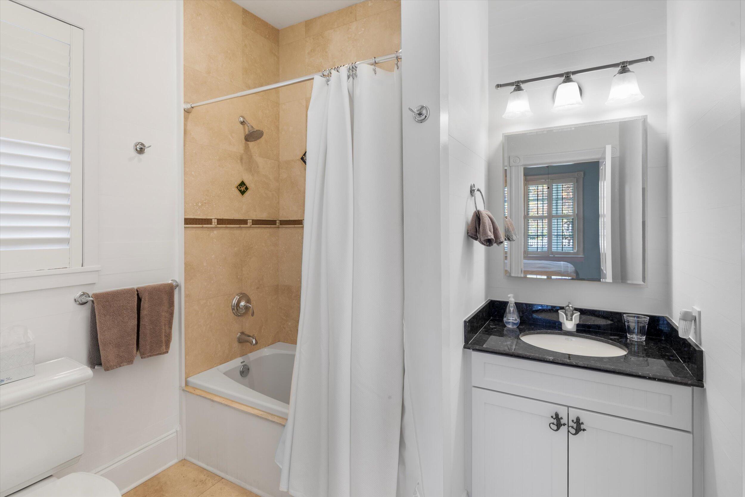 709 Eaton Street Key West, FL 33040 - Photo 20 of 37 a bathroom with a granite countertop sink a mirror and a shower