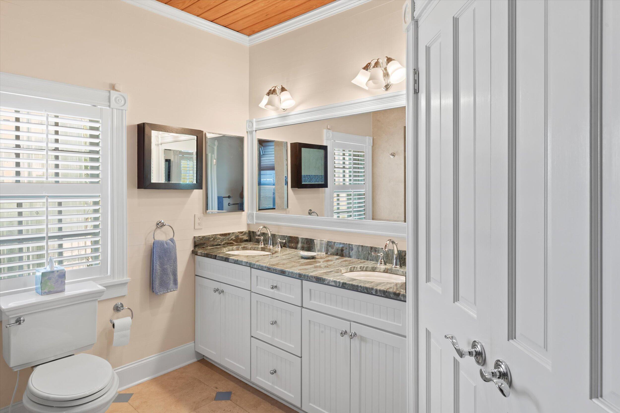709 Eaton Street Key West, FL 33040 - Photo 29 of 37 a bathroom with a granite countertop sink toilet and mirror
