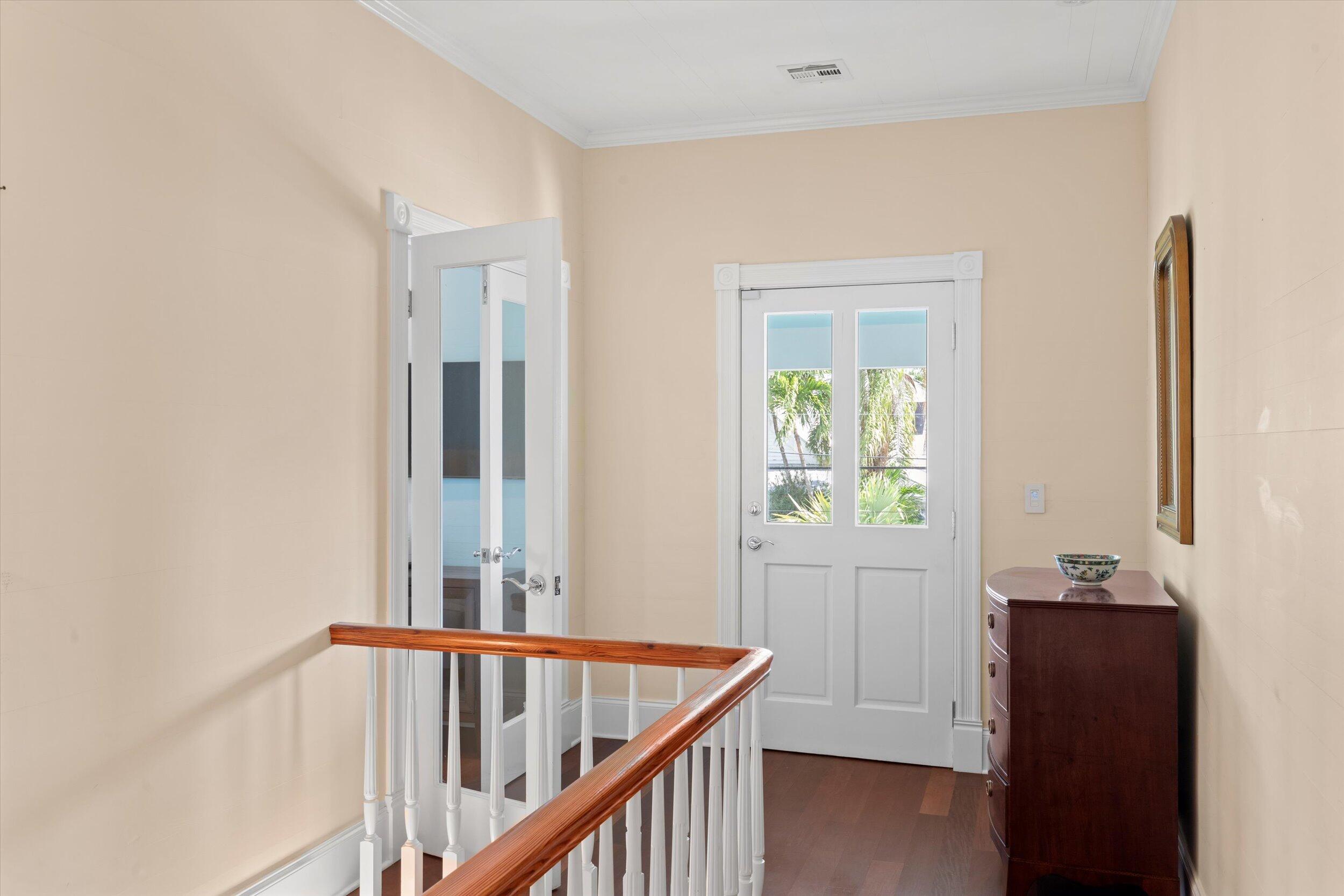 709 Eaton Street Key West, FL 33040 - Photo 32 of 37 a view of a hallway to a livingroom with wooden floor and windows