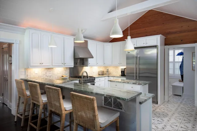 a kitchen with a sink a refrigerator and cabinets