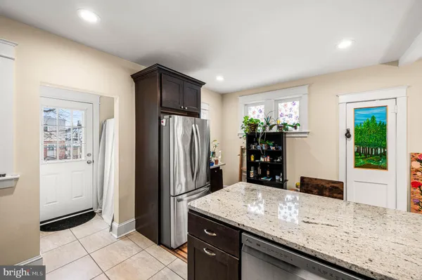 a kitchen with stainless steel appliances granite countertop a refrigerator and a sink