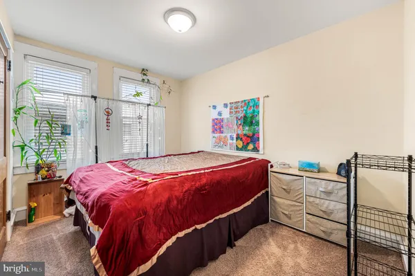 a bed sitting in a bedroom next to a window