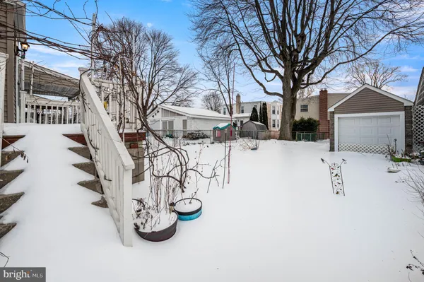 a view of white house with a yard covered in snow