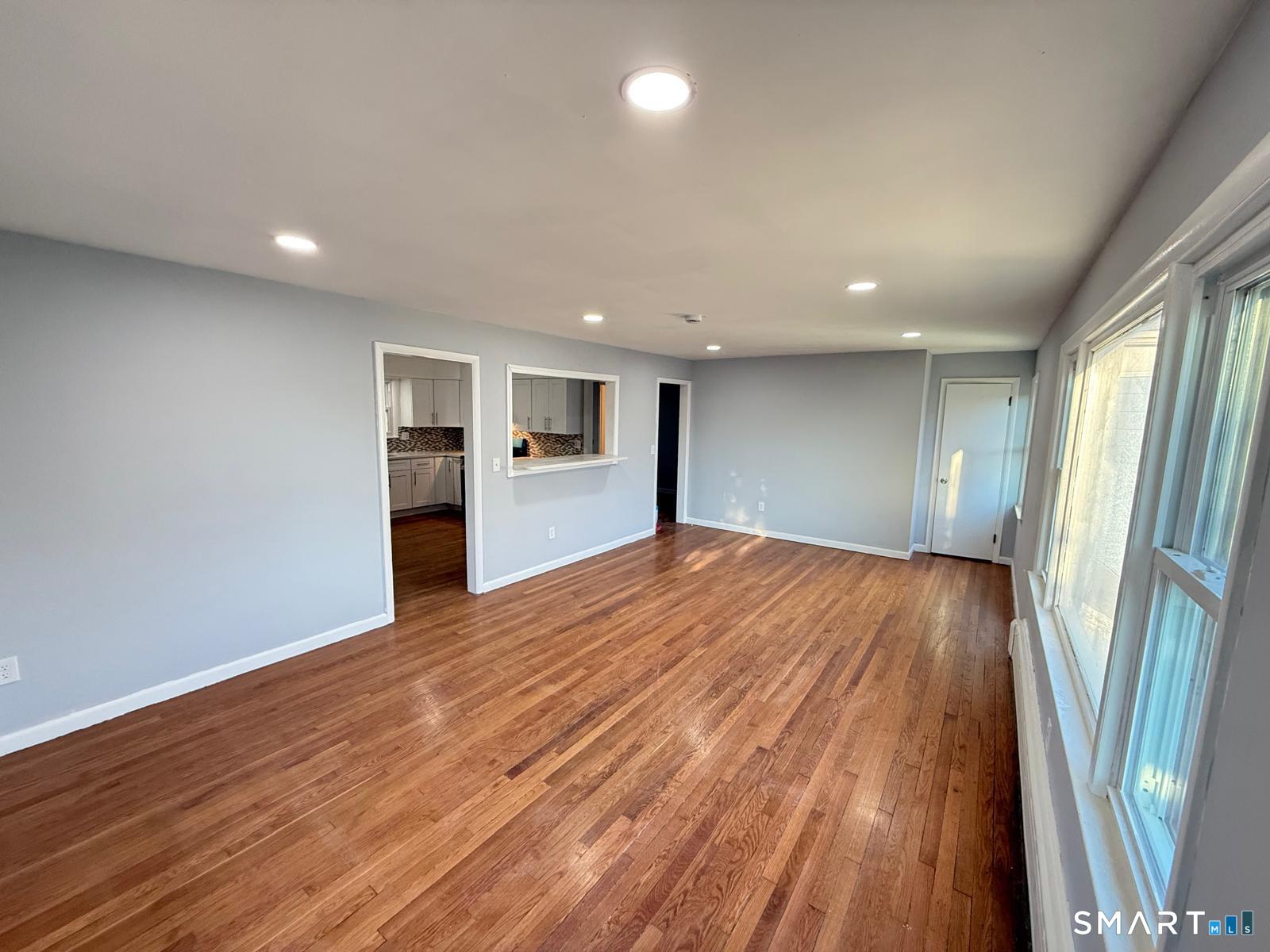 524 Garfield Avenue, Unit 2 Bridgeport, CT 06606 - Photo 4 of 10 a view of an empty room with wooden floor and a window
