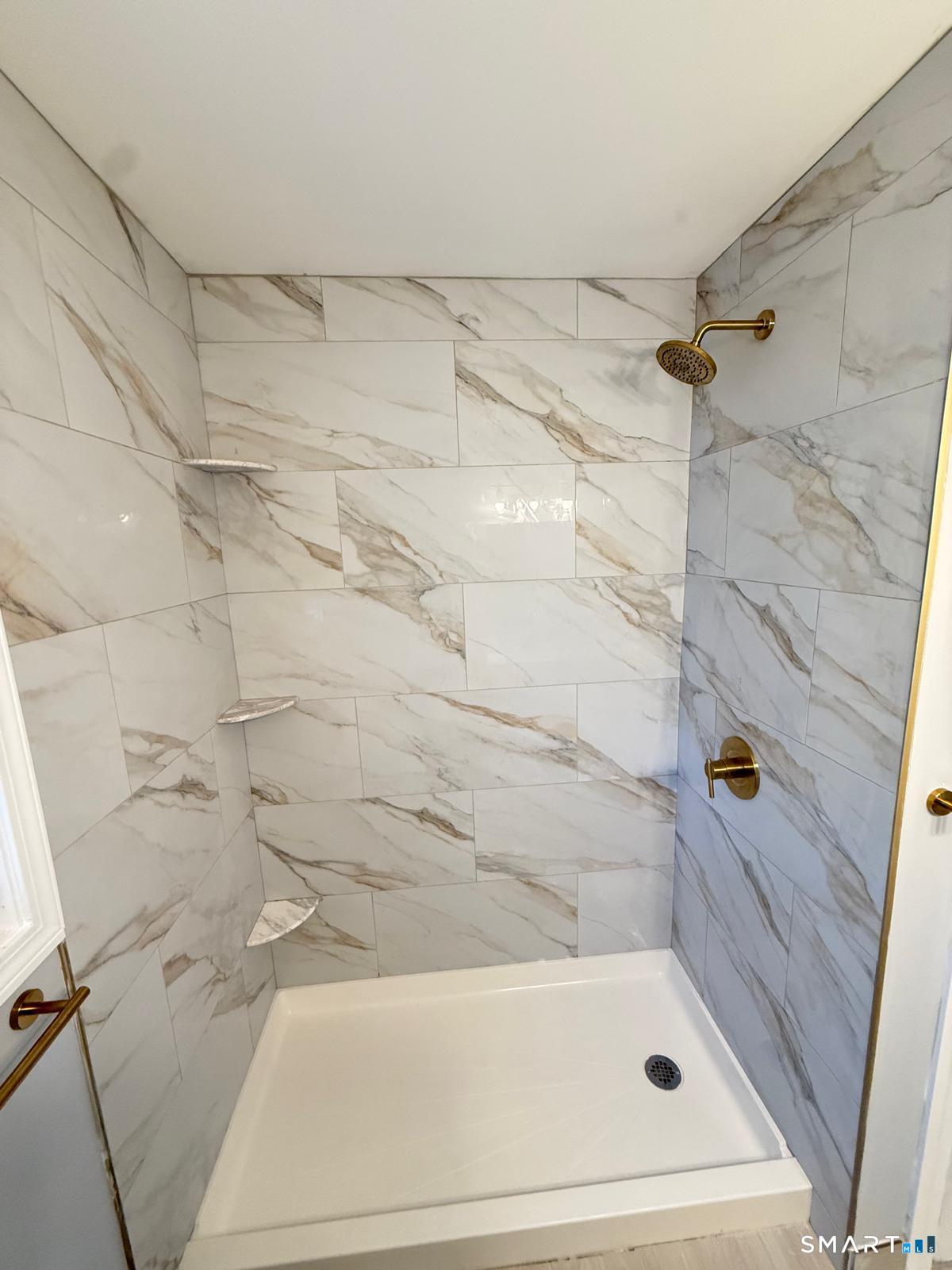 524 Garfield Avenue, Unit 2 Bridgeport, CT 06606 - Photo 9 of 10 a bathroom with a shower and a bath tub