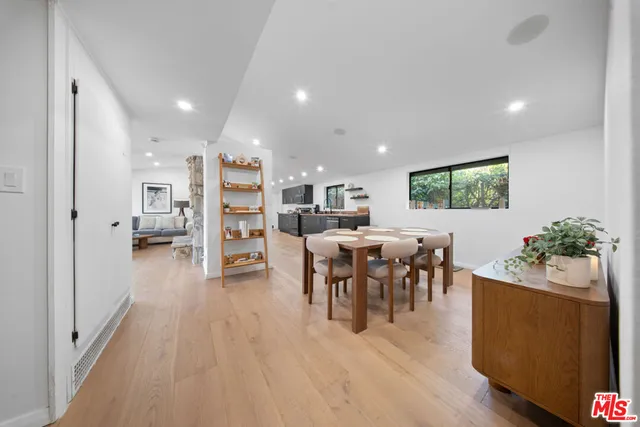 a view of a hallway with workspace and a window
