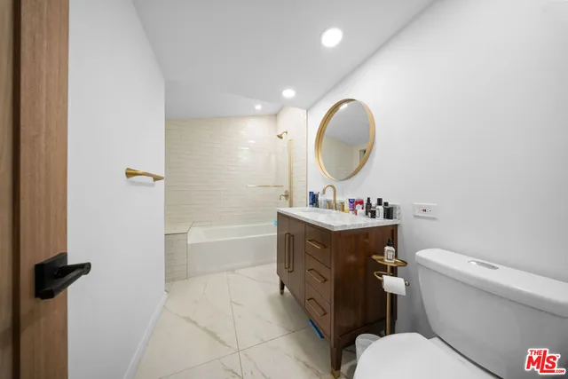 a bedroom with a bed and a desk