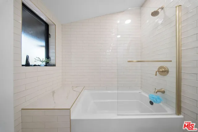 a bedroom with a bed wooden floor and window