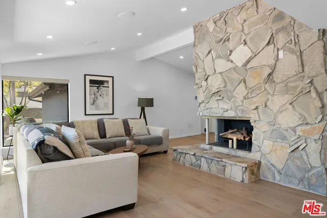 a living room with fireplace furniture and a fireplace