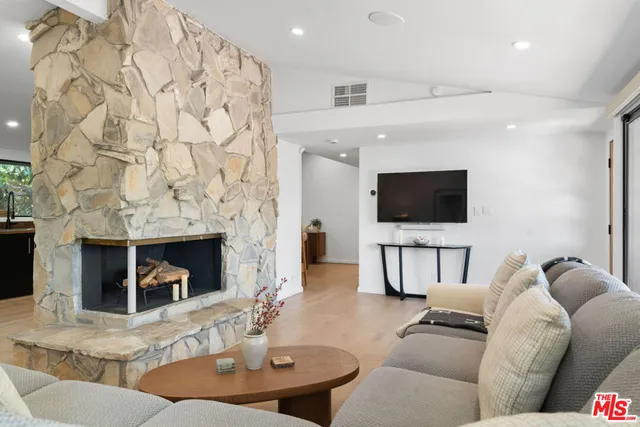 a kitchen with stainless steel appliances granite countertop a stove a sink dishwasher and a refrigerator