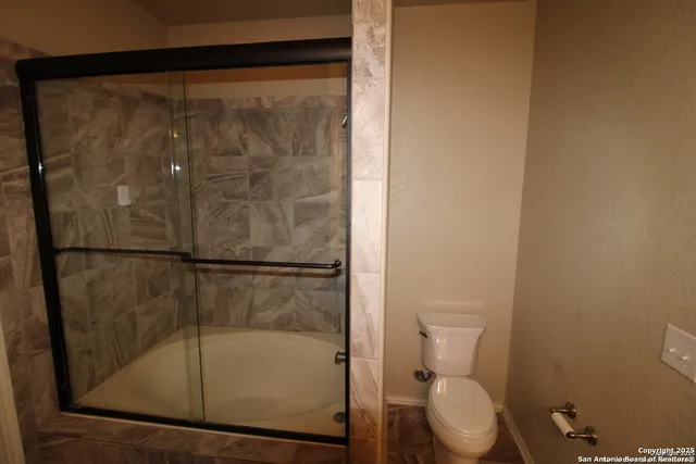a bathroom with a shower and a toilet
