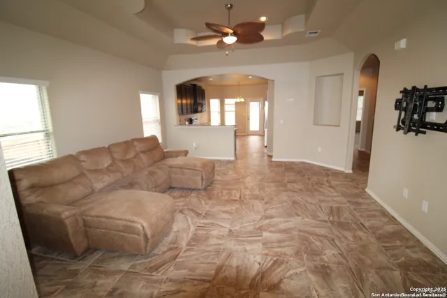 a living room with furniture and a chandelier