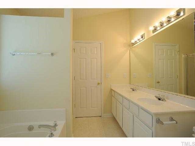 5101 Marathon Lane Raleigh, NC 27616 - Photo 7 of 11 a bathroom with a sink and a mirror