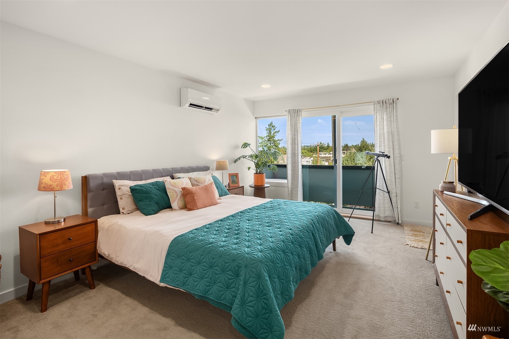 4209 Southwest Frontenac Street Seattle, WA 98136 - Photo 15 of 36 a bedroom with a bed and a flat tv screen on dresser