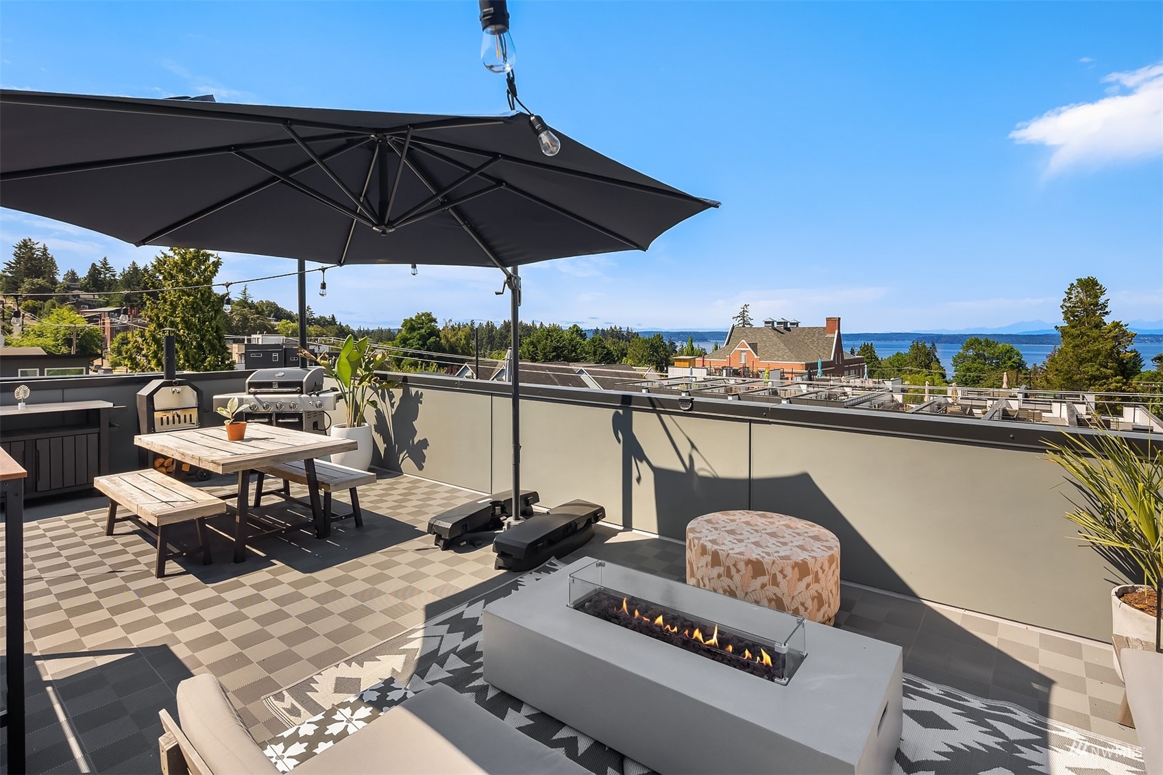 4209 Southwest Frontenac Street Seattle, WA 98136 - Photo 31 of 36 a view of a balcony with chairs and an umbrella